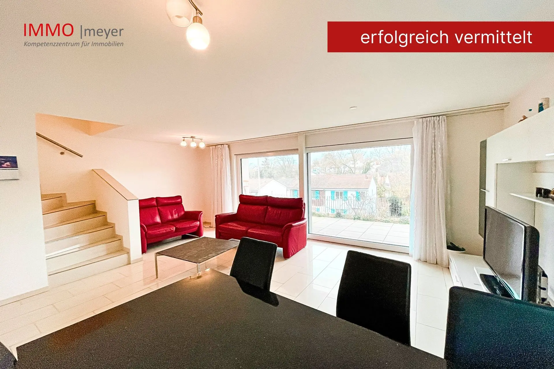 Wohnraum mit Parkettboden, Treppe und Glasfront